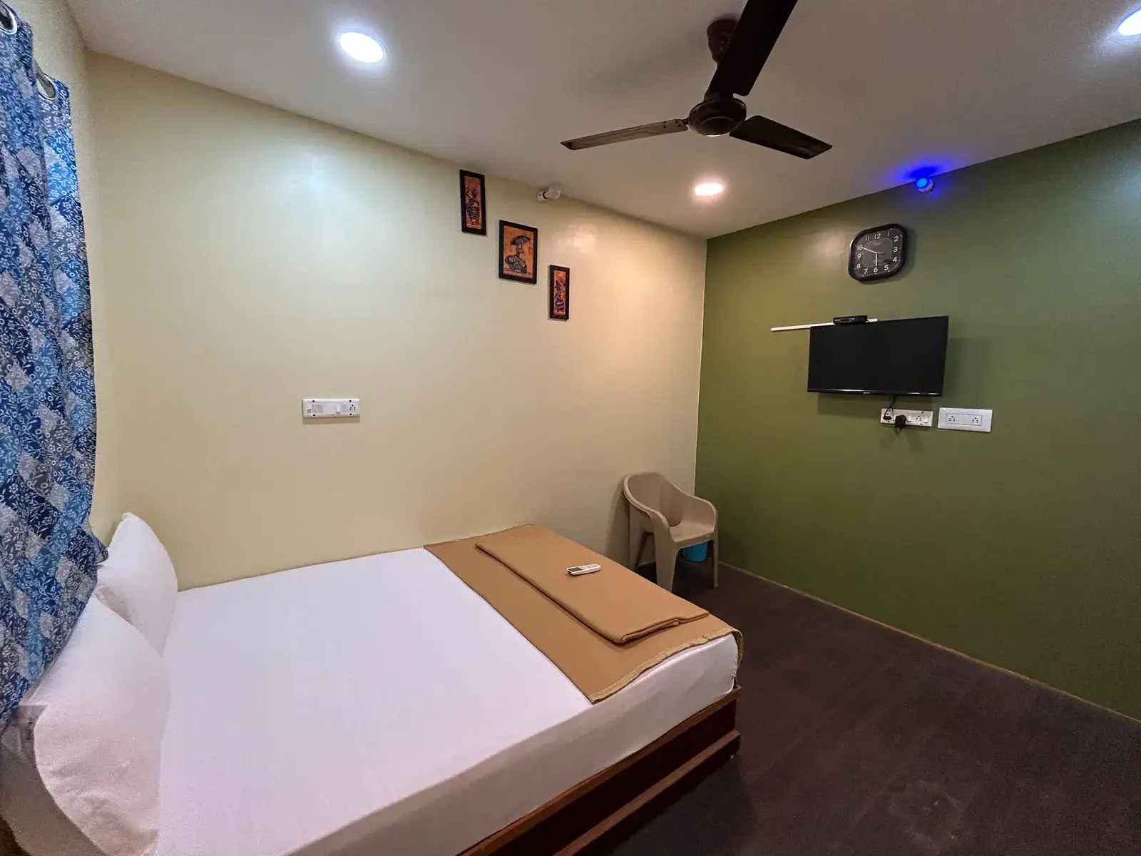 SHA Queen Room with a queen-size bed, a chair and a wall-mounted television